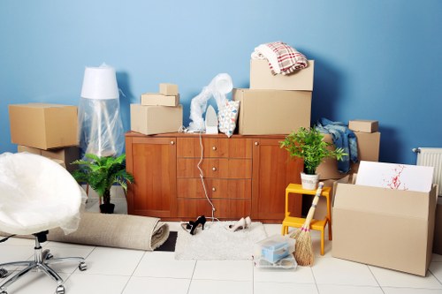 Professional movers carrying furniture in Brondesbury
