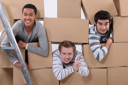 Loading household furniture into a removals van in Brondesbury