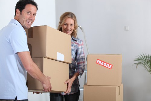 Packed moving boxes and furniture ready for transport in Brondesbury