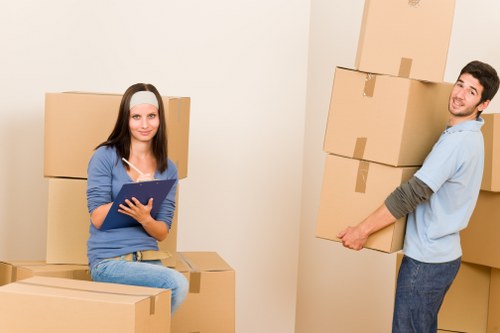 Professional movers handling furniture in a Brondesbury flat